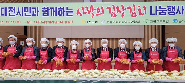 농협중앙회 대전지역본부와 한국농업경영인 대전시연합회, 고향주부모임, 농가주부모임 관계자들이 11일 농업인의 날을 맞아 대전시 농업기술센터에서 '농협 창립 60주년 기념사랑의 김장김치 나눔 행사'를 열고 기념촬영을 하고 있다. 이날 담근 김치 2000포기는 고령?독거농업인 및 지역사회 취약계층에 전달될 예정이다. 농협중앙회 대전지역본부 제공