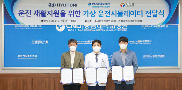 현대자동차 최원준 팀장(왼쪽)과 안전생활실천시민연합 고영주 본부장(오른쪽)이 19일 충남대병원에서 대전충청권역의료재활센터 복수경 센터장에게 장애인의 운전재활을 위한 가상운전시뮬레이터를 전달한 후 기념촬영을 하고 있다. 가상운전시뮬레이터는 운전에 어려움을 겪는 장애인들의 운전평가와 훈련, 도로주행 연수 등을 돕기 위해 전달됐다. 충남대병원 제공