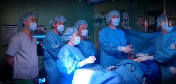 미국에서 연수를 위해 대전우리병원을 찾은 척추 명의들이 27일 대전우리병원 박철웅 대표원장(오른쪽 두 번째)의 수술을 지켜보고 있다. 대전우리병원 제공