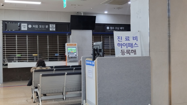 지난 2일 휴일로 인해 불 꺼진 대전의 한 병원 접수대에 보호자가 앉아있다.