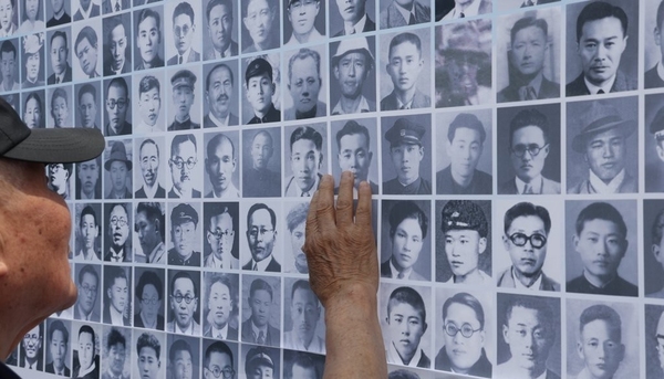 지난해 6월 28일 경기도 파주시 임진각 국립 6·25전쟁납북자기념관에서 열린 제10회 6·25 납북희생자 기억의 날 행사에서 납북희생자 가족이 납북된 가족의 사진을 쓰다듬고 있다. 연합뉴스